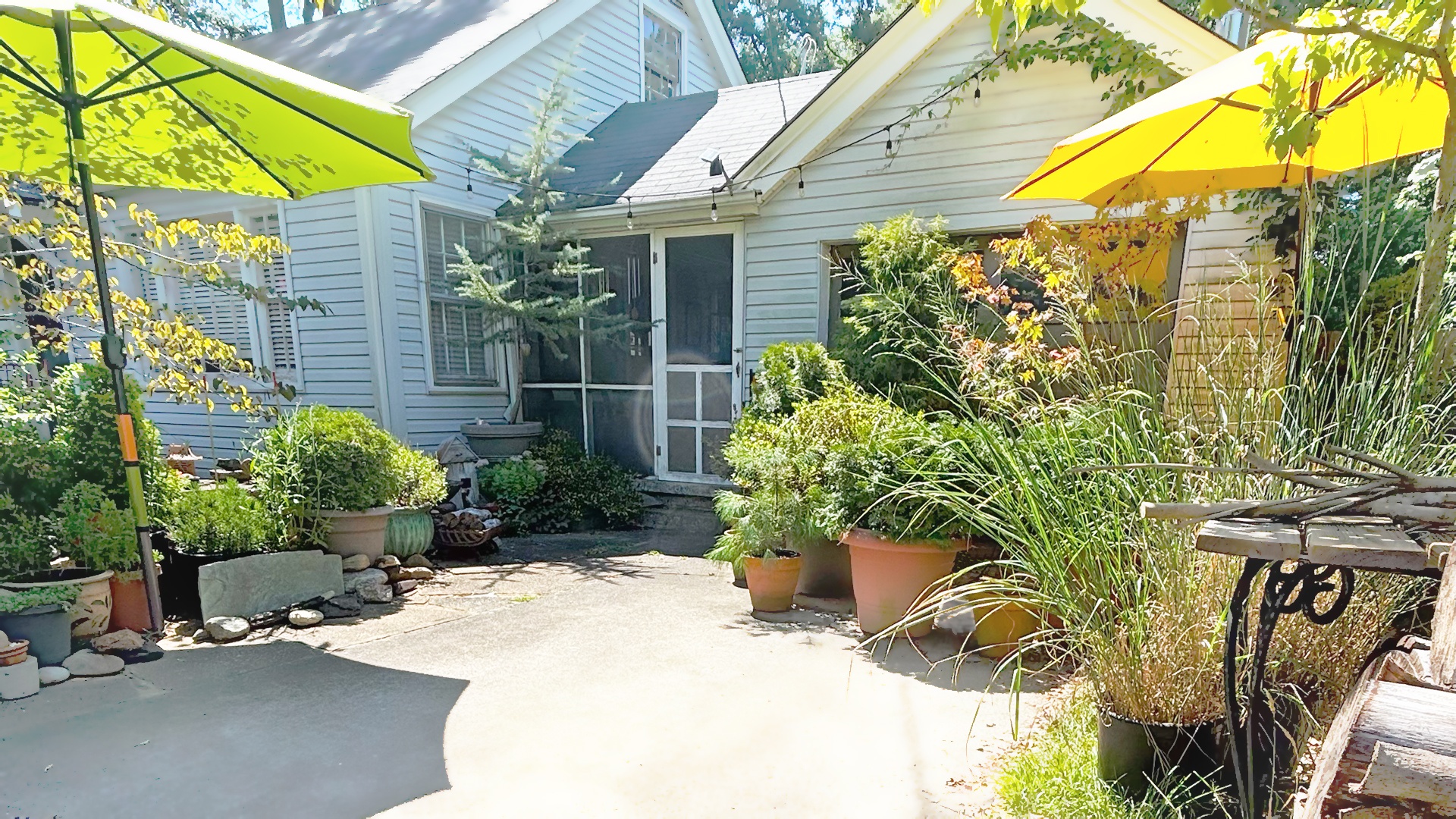Front exterior with sun umbrellas at Wilkinson ART Gallery in Greenville SC